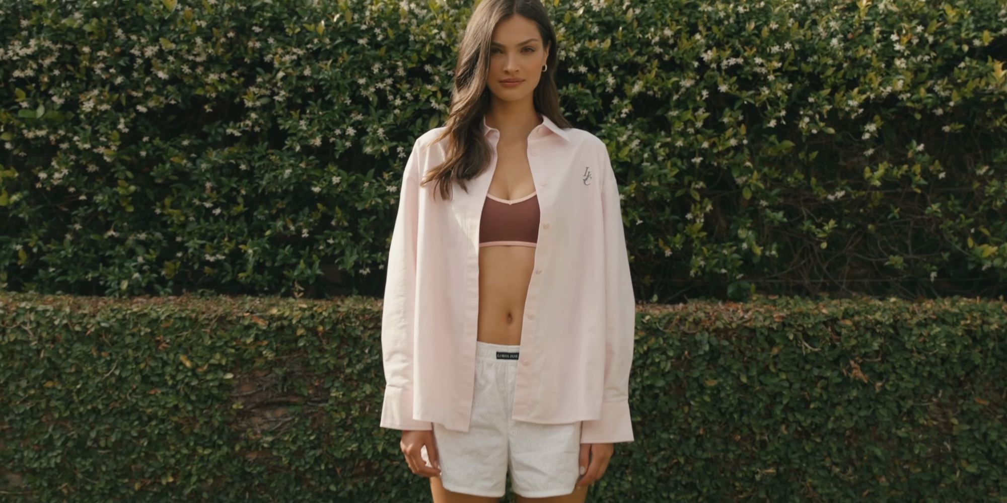 Two women walking on grass