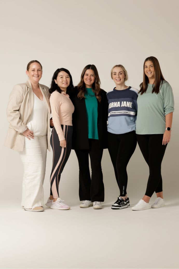 Five women standing together