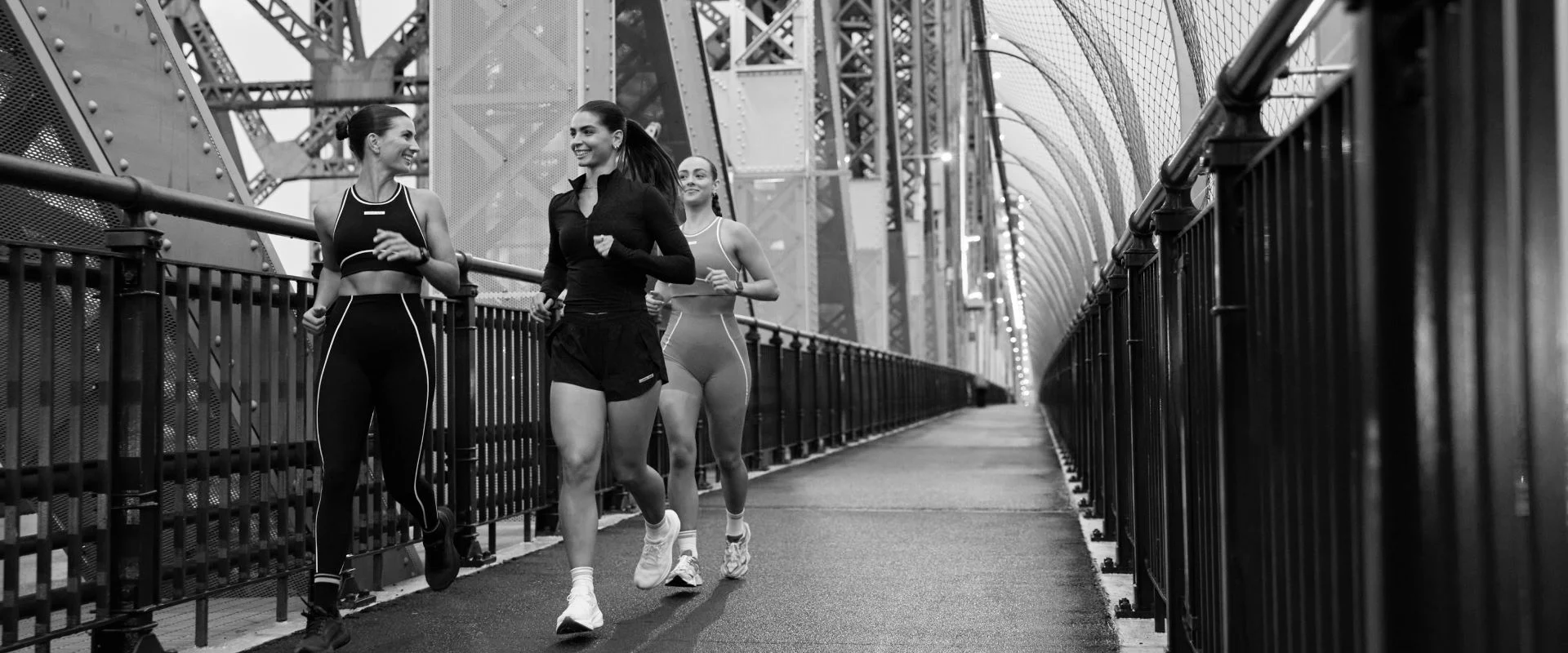 Three women running on bridge