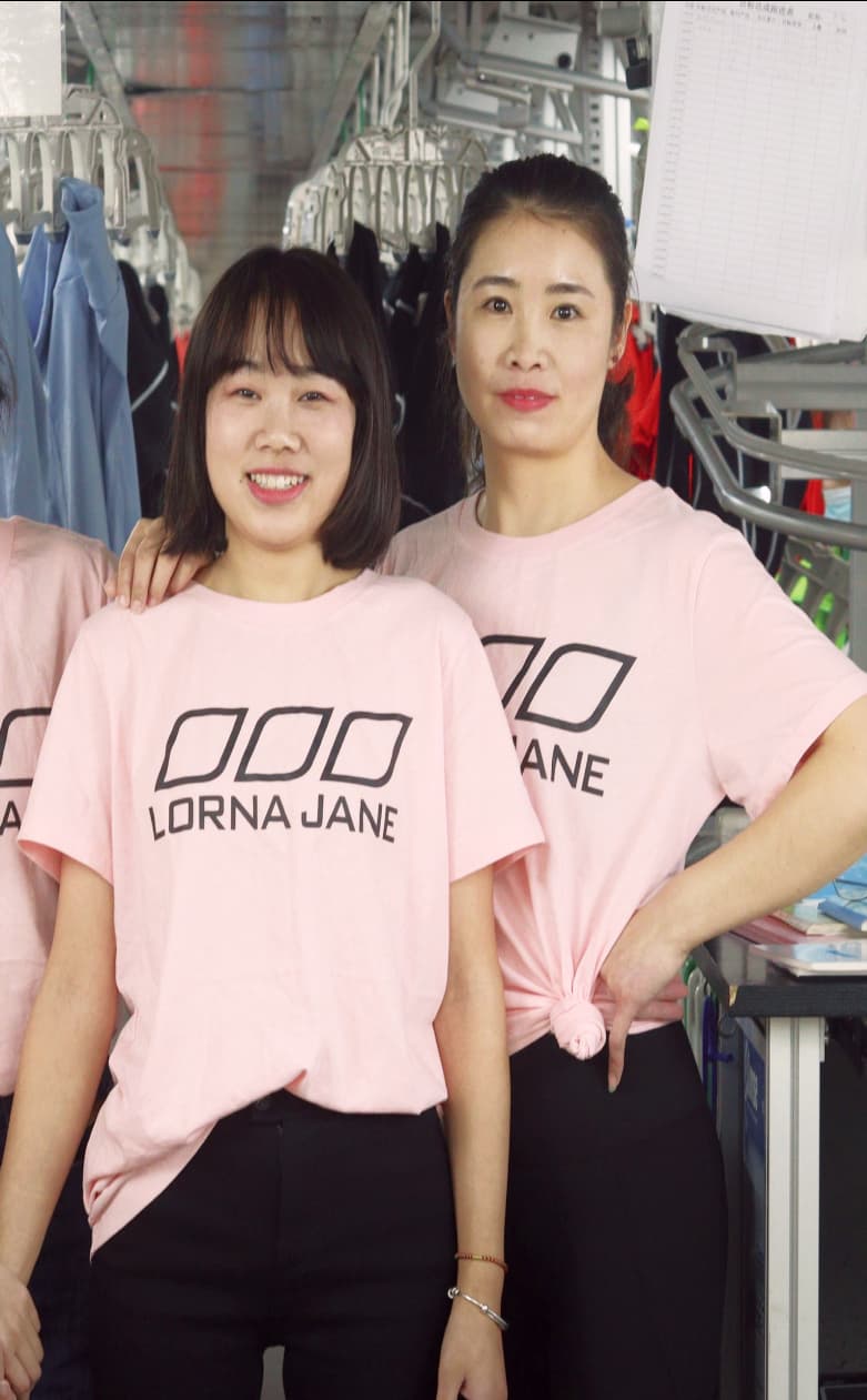 Two employees wearing Lorna Jane t-shirts