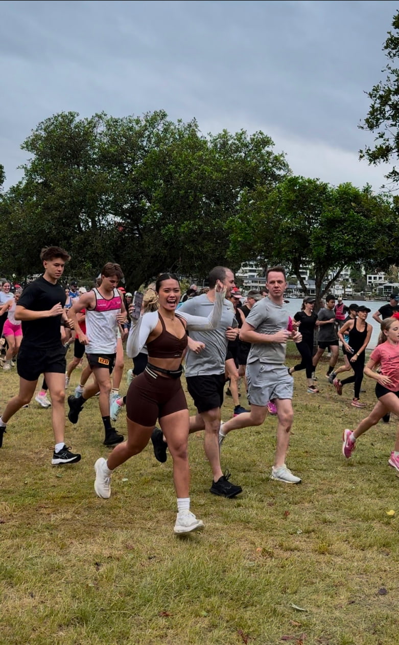 Women and men running in a park