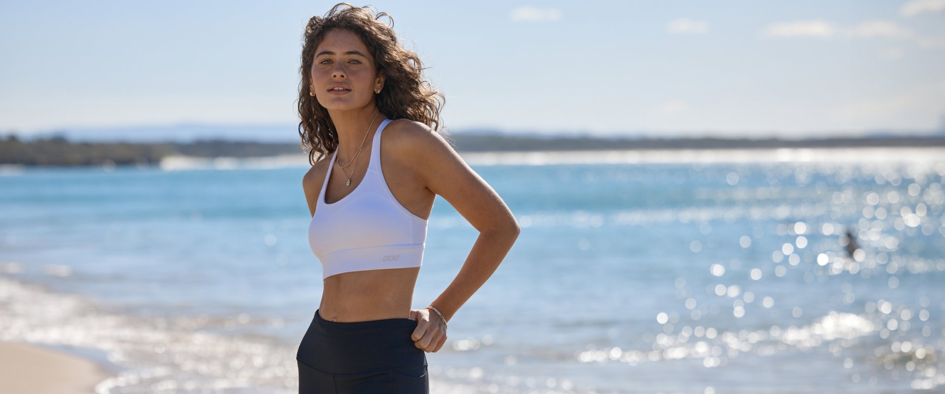 Three women wearing sports bras