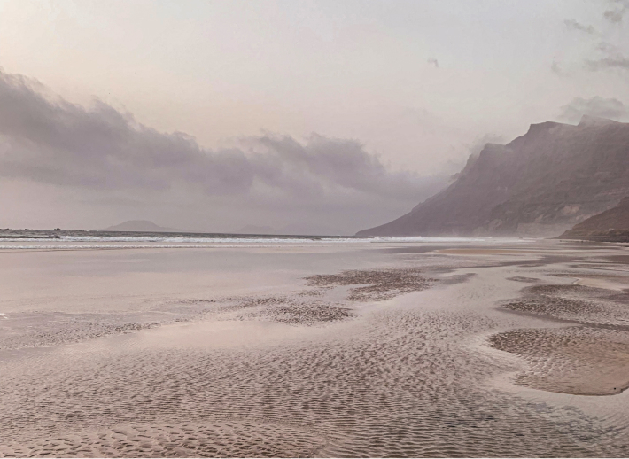 Beach with water and mountain in background