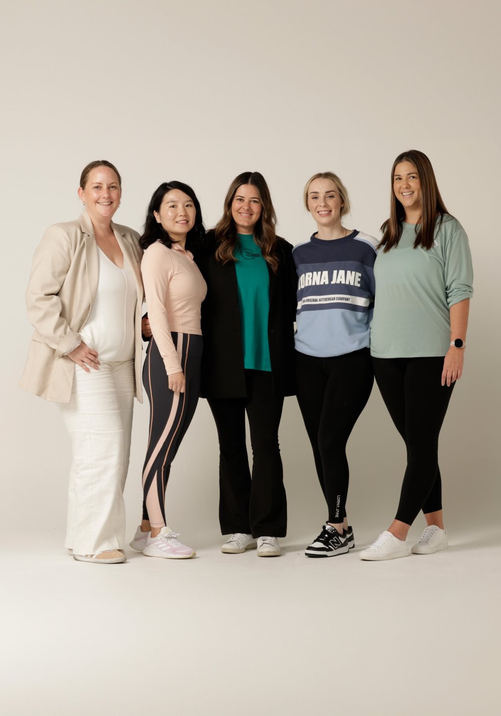 Five women standing together