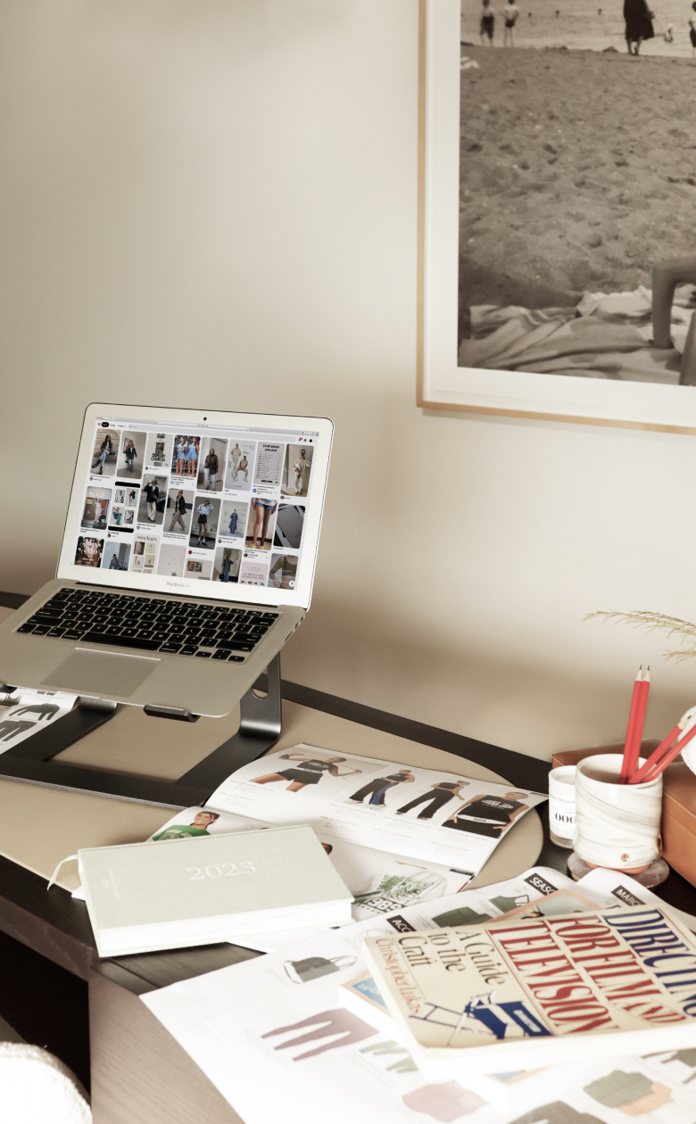 Desk and computer with pictures of clothing