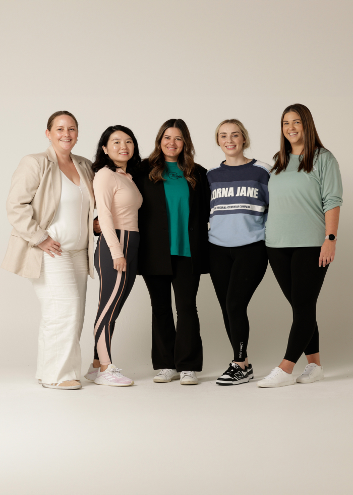 Five women standing together